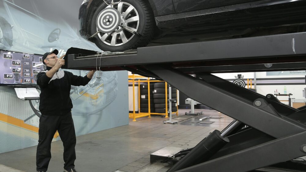 mechanic repairing car after collision